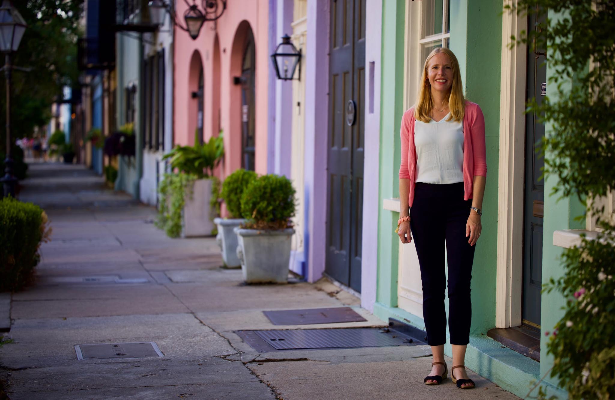 Darley Newman standing along Rainbow Row in historic Charleston, South Carolina